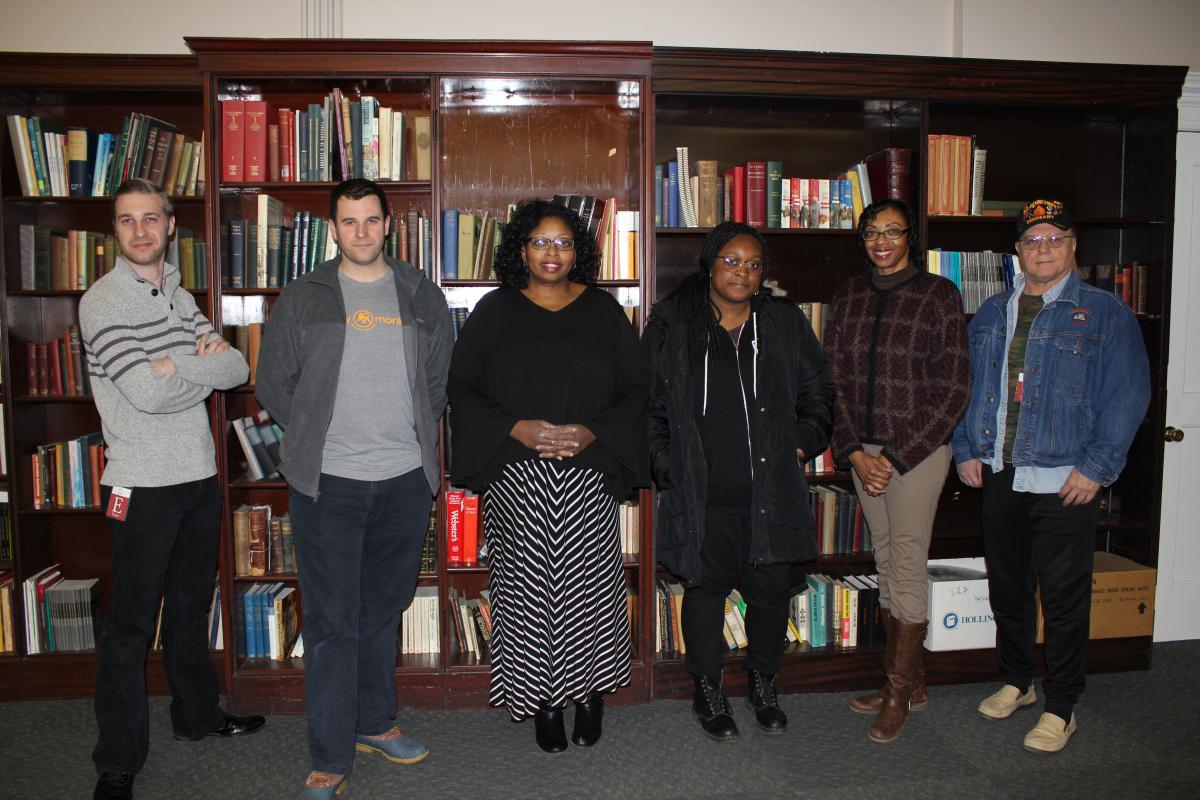 Discussion participants pose in front of bookshelves at the Historical Society of Pennsylvania