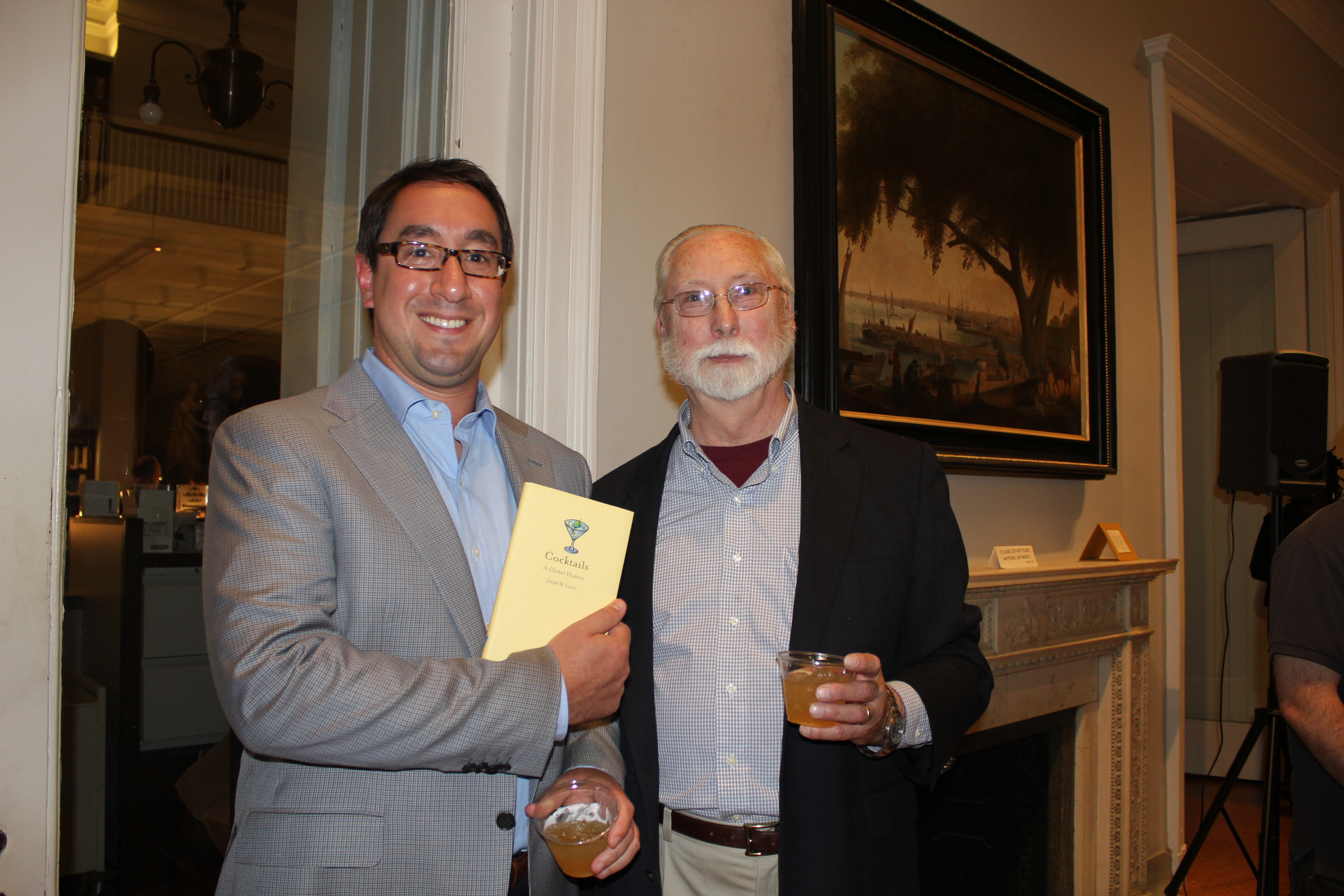 Young Friends Committee Chair Kevin Passerini and speaker Joseph Carlin enjoy glasses of Fish House Punch.