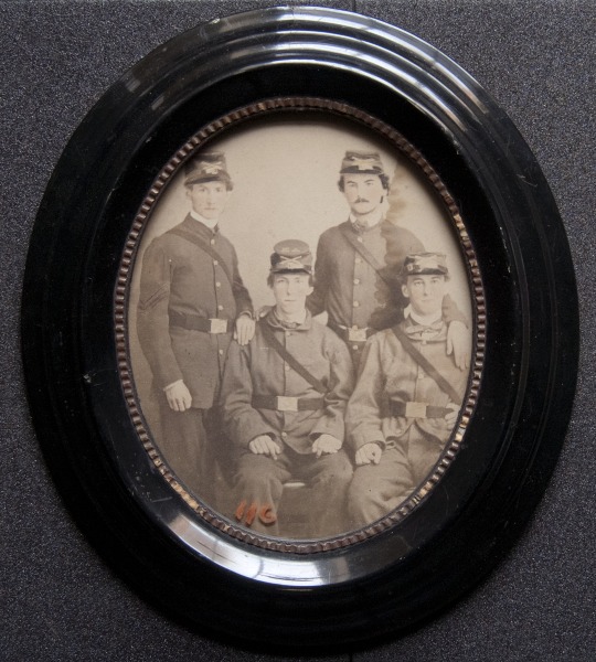 Image of four men (identities unknown) in uniform